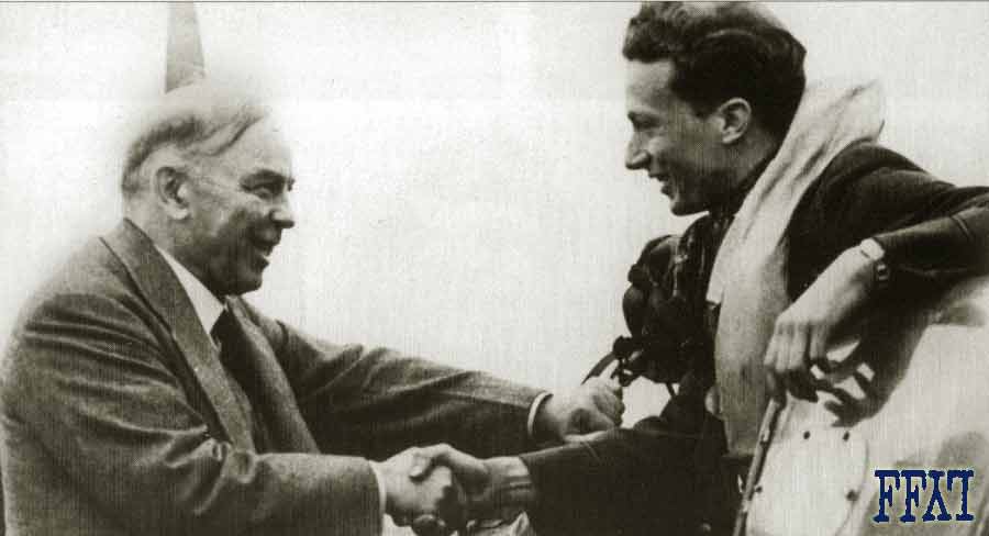 Canadian Prime Minister Mackenzie King shakes hands with American RCAF pilot Tex Ash during a visit to 411 Sqn. - 6 September 1941